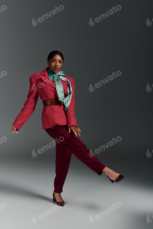 Preview: Young woman showcases bold fashion in stylish attire within a studio setting