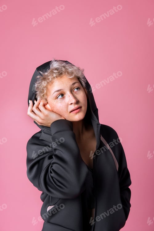 Preview: Girl wearing a black hoodie and headphones