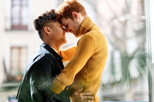 Preview: Gay couple embracing on the terrace at home