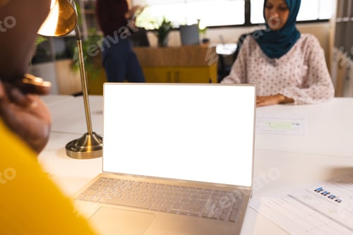 Preview: African american casual businesswoman using laptop with copy space in creative office