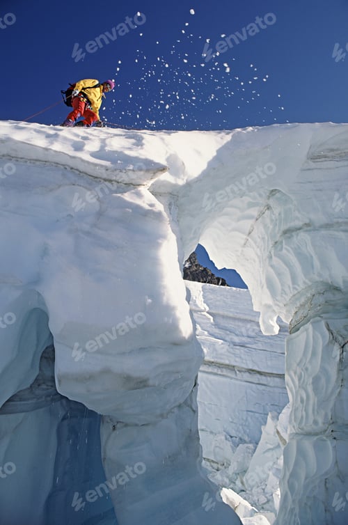 Preview: Climber crossing snow bridge on coleman glacier