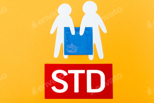 Preview: top view of paper people near blue condom and std lettering isolated on orange