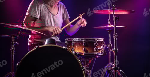 Preview: Drummer Plays Drums on Stage with Color Lights