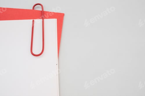 Preview: Closeup shot of red and white papers attached on a gray background