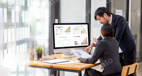 Preview: Team of confident Asian business people point to graphs and charts to analyze market data, balance