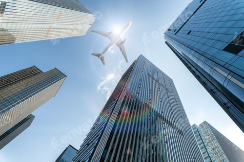 Preview: airplane fly over modern office buildings with sunshine.