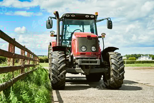 Preview: Red Tractor on Farm Road Under Blue Sky