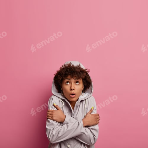 Preview: Turn on heater, its cold. Surprised freezing woman trembles during windy rainy weather, hugs herself