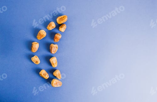 Preview: Dried dates in crescent shape on blue.