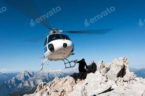 Preview: Helicopter dropping BASE jumpers on mountain, Dolomites, Italy