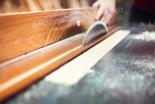 Preview: Carpenter sawing wooden planks