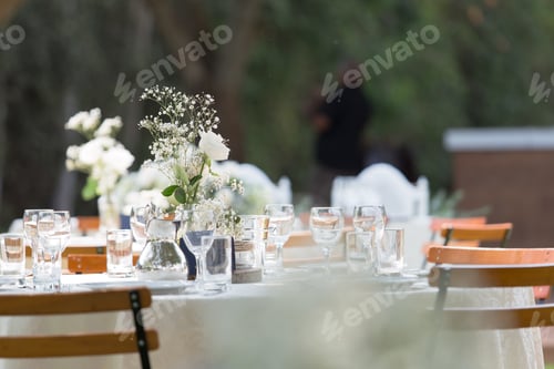Preview: Table with beautiful utensils and centerpieces, for a wedding reception outdoors