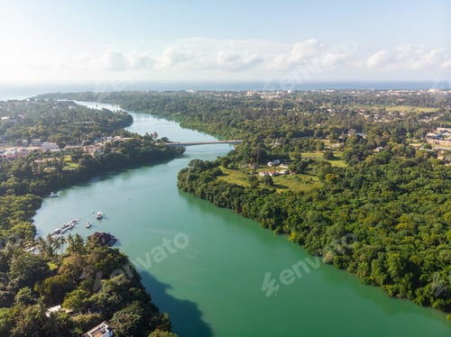 Preview: High angle shot of a river going through the tropical forest captured in Mombasa, Kenya