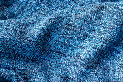 Preview: Bright blue knitted fabric texture. Crumpled blanket background. Selective focus. Closeup view