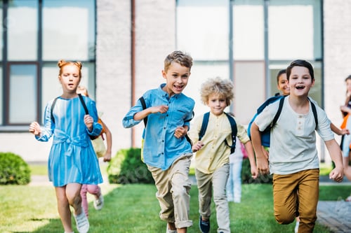 Preview: group of adorable scholars runing by school garden