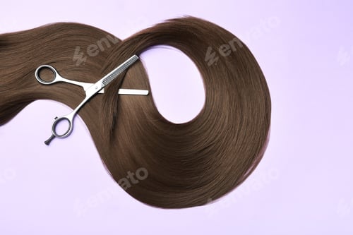 Preview: Lock of brown straight hair and thinning scissors on color background, flat lay