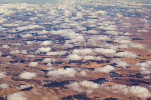 Preview: Clouds over a desert landscape. View from the airplane window