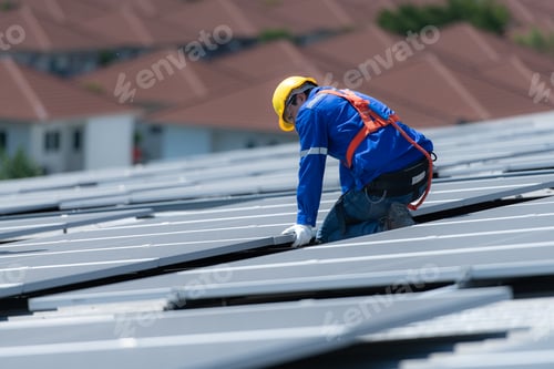 Preview: A technician is installing solar panels on the roof of the warehouse