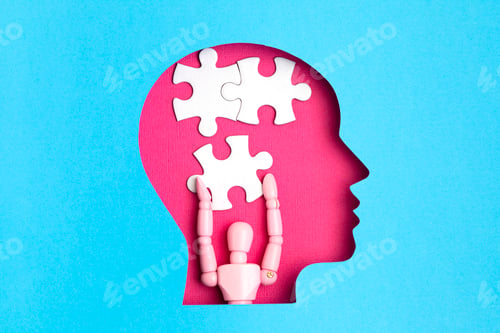 Preview: Papercut head with jigsaw puzzle pieces inside. Mental health problems, psychology, memory, logic