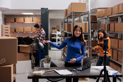 Preview: Woman streaming warehouse workers managing dispatching for social media