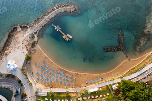 Preview: Drone aerial of tropical sandy beach. Beach umbrellas people swimming and relaxing. Summer vacations