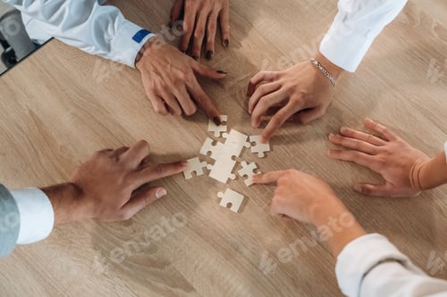 Preview: Focused top view of office workers that are playing puzzle game, conception of success