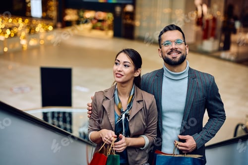 Preview: Young couple spending a day in shopping at the mall.