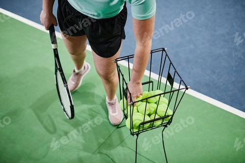 Preview: Tennis Player Choosing Balls