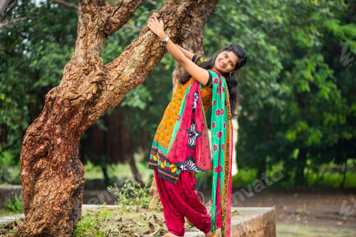 Preview: Young girl near tree trunk and she enjoying fresh air outdoors