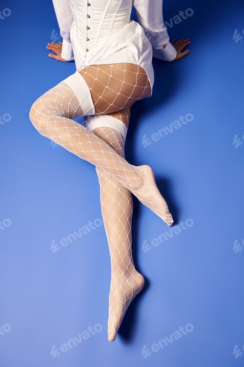 Preview: Ethereal elegance: woman in white shirt & fishnet stockings