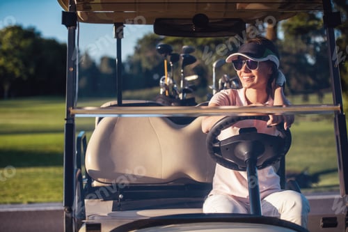 Preview: Woman in Golf Cart on Sunny Course