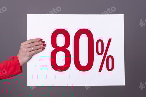 Preview: Female hand holding a 80% poster. Studio shot. Commercial concept.