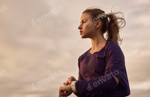 Preview: Sporty woman with fitness tracker in nature