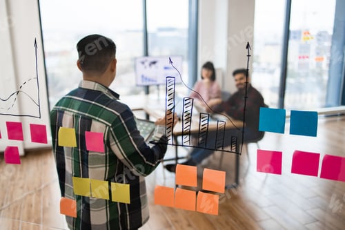 Preview: Team brainstorming session with charts and sticky notes