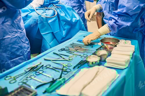 Preview: sterile operating table in the operating room with a variety of surgical tools in a row.