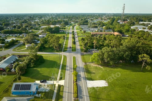 Preview: Aerial view of street traffic with driving cars in small town America suburban landscape
