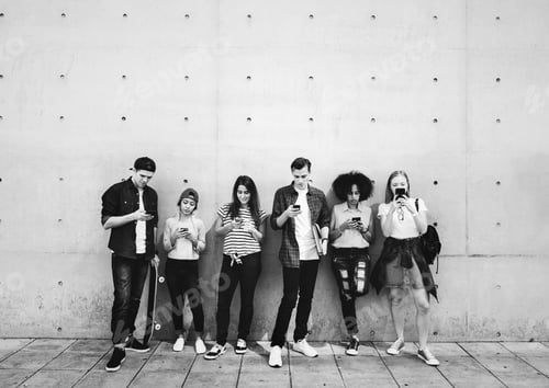 Preview: Group of young adults outdoors using smartphones together and ch