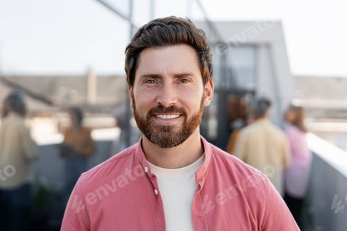 Preview: Smiling man wearing casual clothes looking at camera posing on the street. Confident businessman