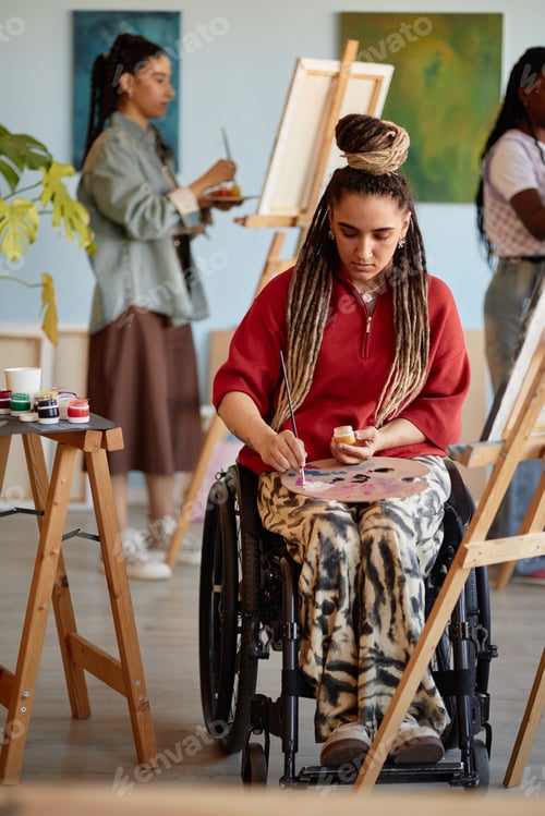 Preview: Girl with Disability Painting on Canvas in Art Studio