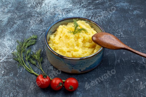 Preview: Side view of mashed potatoes served with dill wooden spoon fresh tomatoes on dark color background