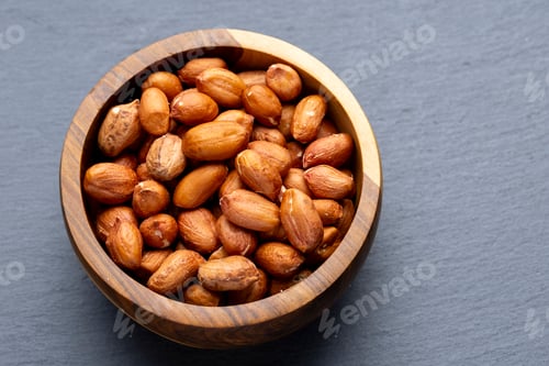 Preview: Roasted Peanuts in Wooden Bowl on Gray Background