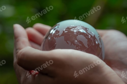 Preview: Crystal globe on hand. Environmental ESG concept. Society and Governance Sustainable global