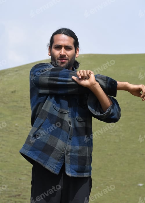 Preview: Front view of a young guy doing Cross Body Shoulder Stretch exercise in outdoor.