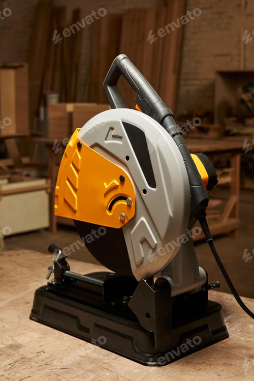 Preview: cutting abrasive disc machine for cutting hard materials stands on a wooden workbench in a carpentry