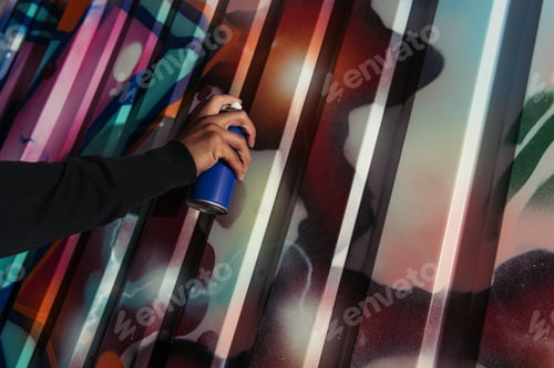 Preview: Cropped view of african american vandal drawing graffiti on wall outdoors