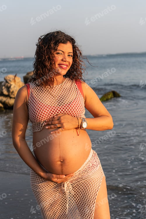 Preview: Smiling Pregnant Woman Posing on Beach