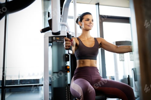 Preview: Beautiful fit young woman training in gym