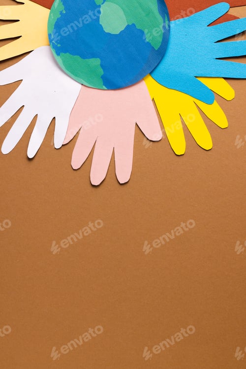Preview: Paper cut out of multi coloured hands and globe with copy space on brown background