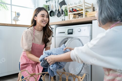 Preview: Asian lovely family doing house working and chores in kitchen at home.