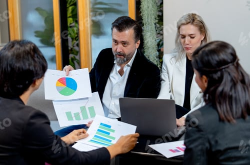 Preview: Close up of Caucasian business man look like manager explain about his work using graph on paper